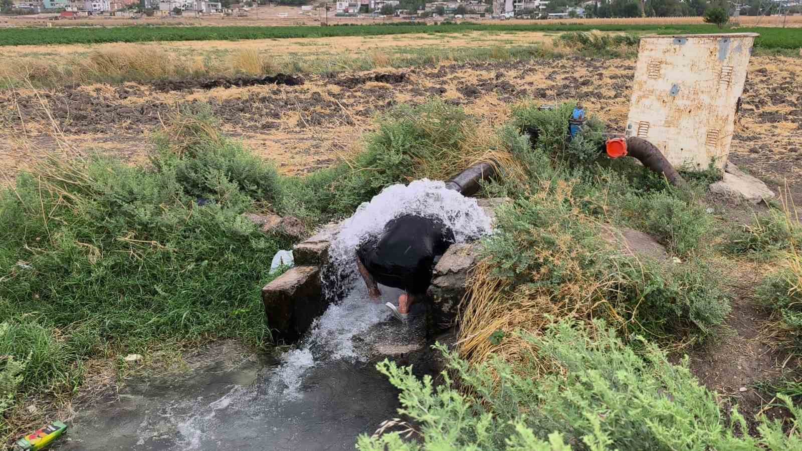 Kavurucu sıcakta elbisesini bile çıkarmadan buz gibi sondaj suyunda serinledi